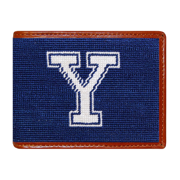 Yale needlepoint bi-fold wallet in navy and white with chestnut leather trim, shown from primary angle.