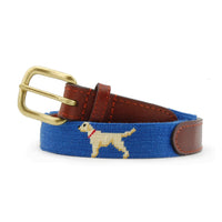 Children’s belt coiled with the stitched design of yellow lab dogs on a blueberry needlepoint background, finished with brown leather ends and a brass buckle.