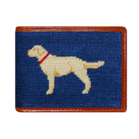 Classic navy needlepoint bi-fold wallet with yellow lab pattern, brown leather trim, shown from primary angle.