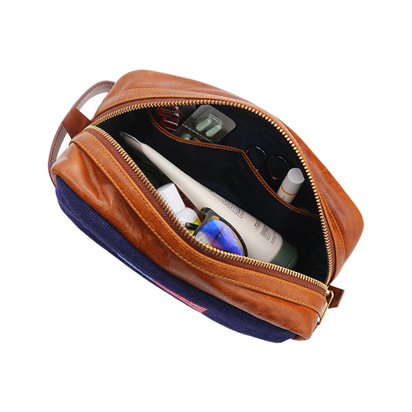 Overview shot of inside of a toiletry bag with examples of content inside.